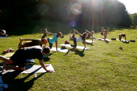 Yoga in the sun drenched meadow in the Apennines 